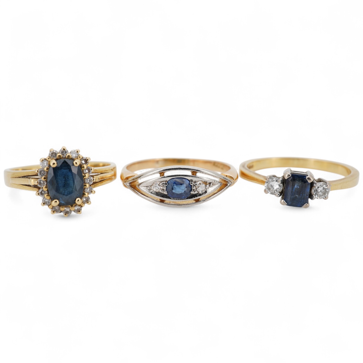 A modern 18ct gold, single stone sapphire and two stone diamond set ring, size O, an 18k, sapphire and diamond set oval cluster ring, size M/N and an 18ct, single stone sapphire and two stone diamond chip set navette sha